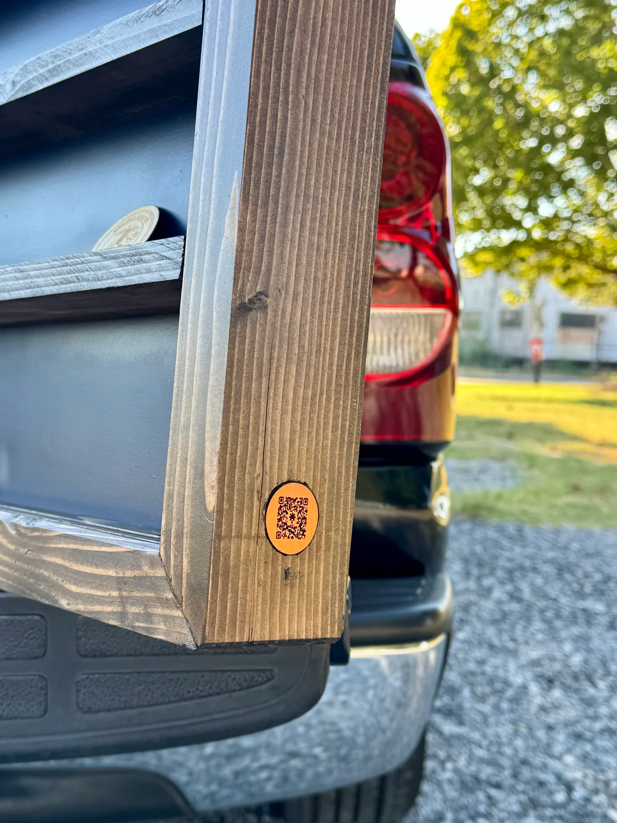 Close up of the IBEW display’s wood frame, coin shelf, and small QR badge