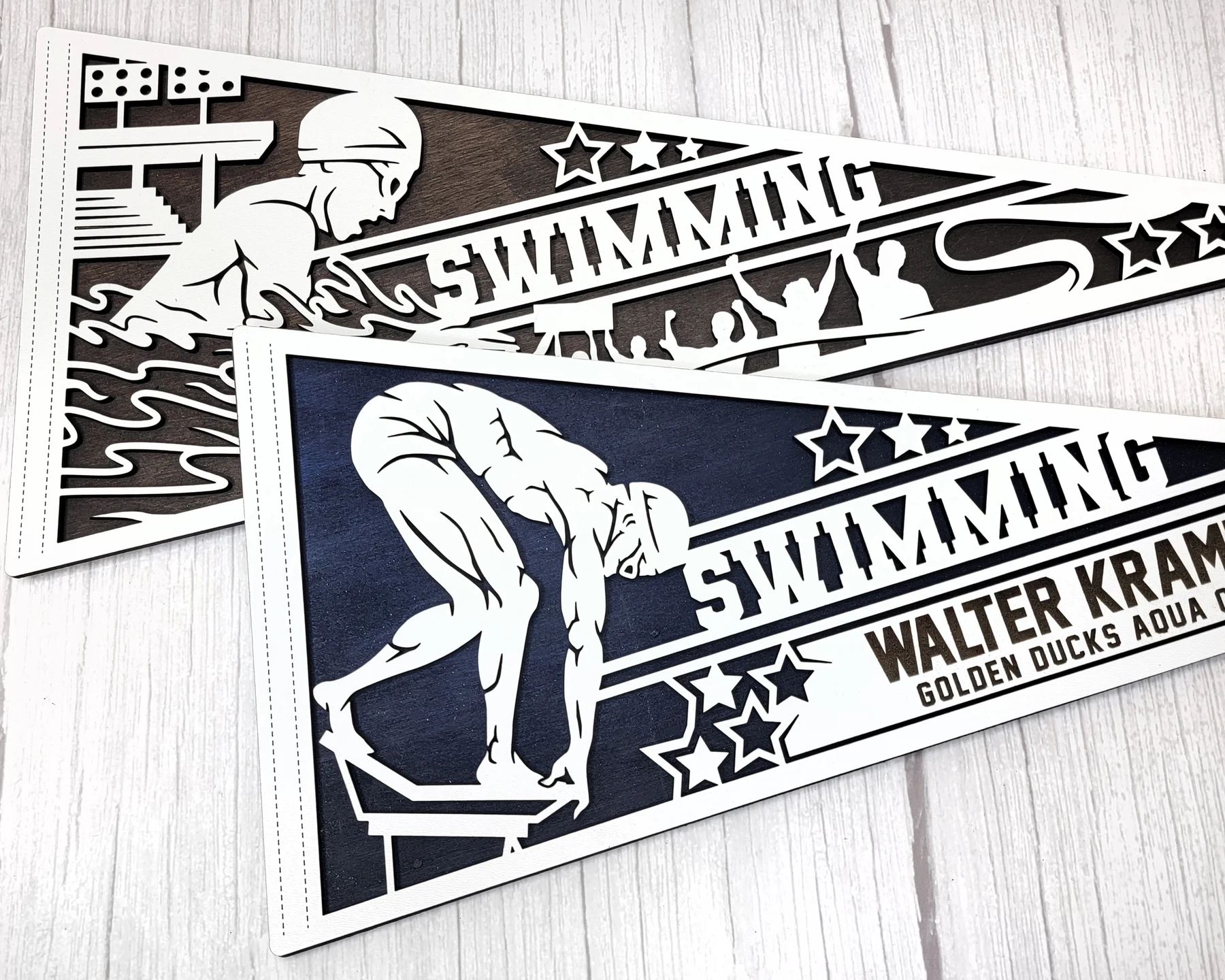 Supplier sample photo of layered swimming pennants with a personalized swimmer name
